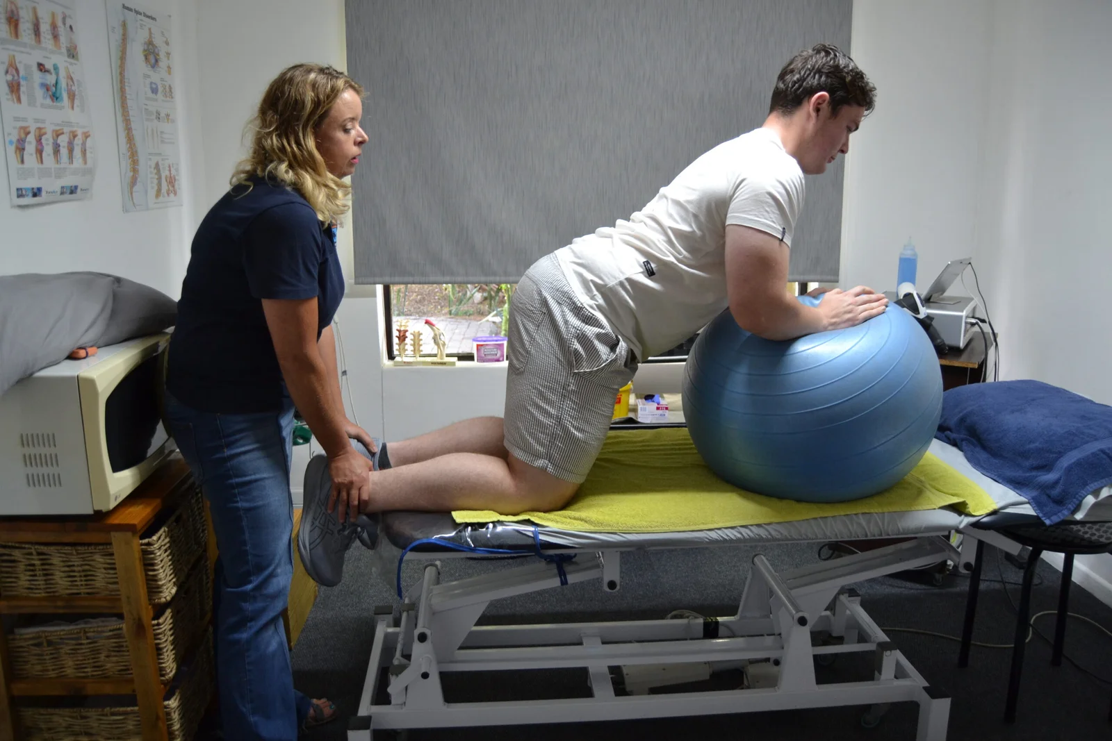 Cecille guiding a patient through a strengthening exercise